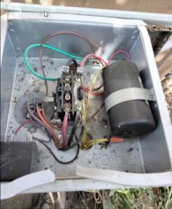 An open electrical box of an HVAC unit showing wiring and a capacitor, indicating service by Desert Air, LLC in Sun Valley, NV.