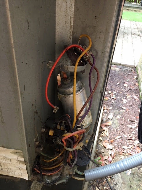 Close-up of electrical components and wiring inside an outdoor HVAC unit during repair by West Tennessee Heat & Air in Memphis, TN