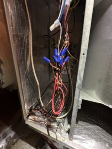 An open HVAC unit revealing electrical connections and wiring, indicating service by Love HVAC LLC in Bluffton, SC.