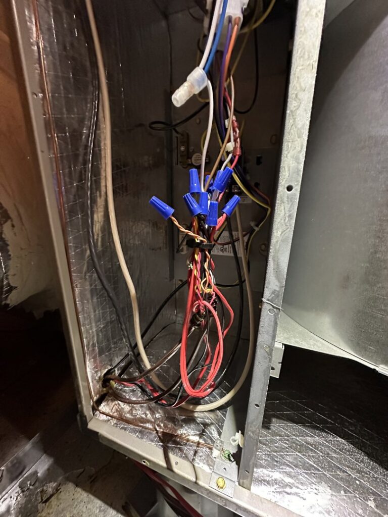 An open HVAC unit revealing electrical connections and wiring, indicating service by Love HVAC LLC in Bluffton, SC.
