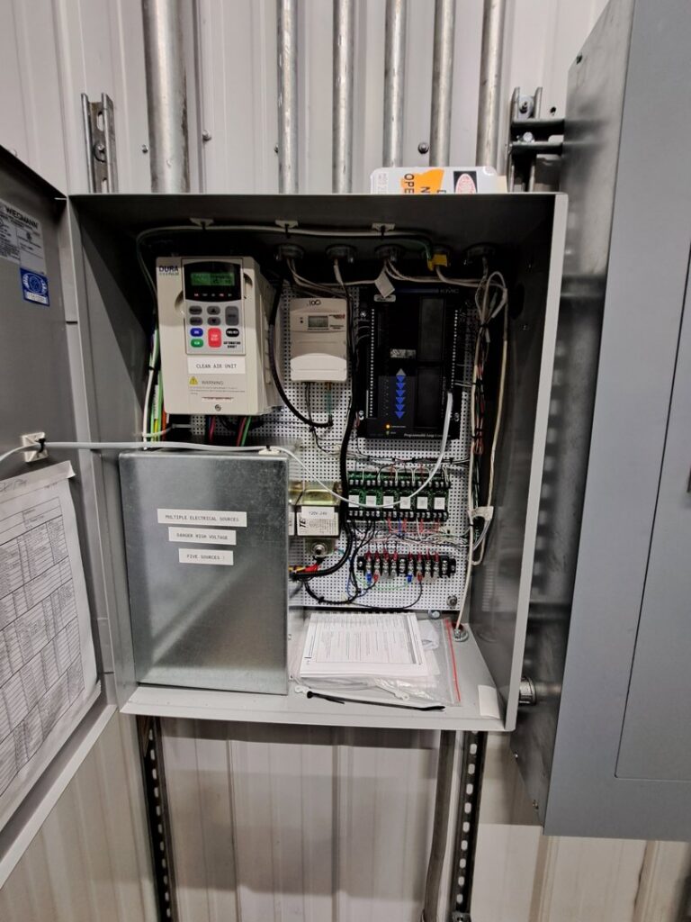 An open electrical control panel for an HVAC system, demonstrating advanced controls by Encode Corporation in Billings, MT.