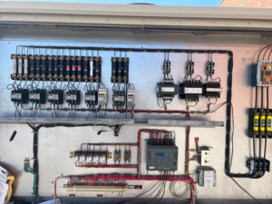 An open electrical control panel showing wiring and components for an HVAC system by Evans Heat & Air in Ruther Glen, VA.