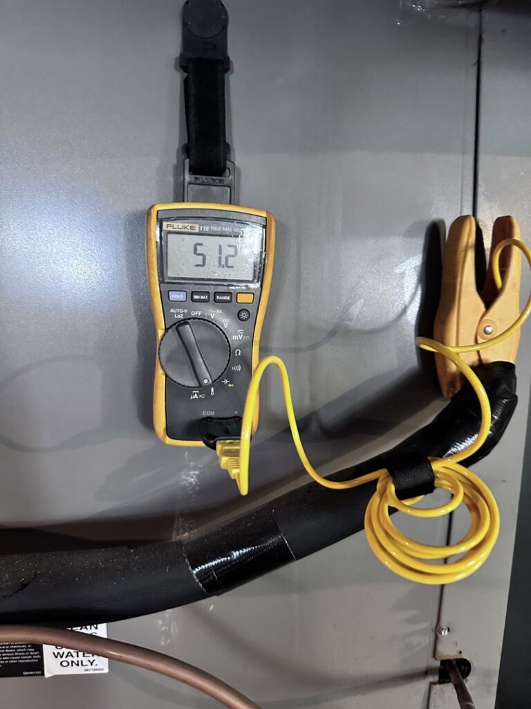 A multimeter showing an electrical reading during an HVAC diagnostic service by Mueller Mechanical HVAC in Philadelphia, PA.