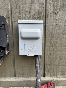 An electrical disconnect box for an outdoor HVAC unit, installed by OnPoint Heating and Air in Commerce City, CO.