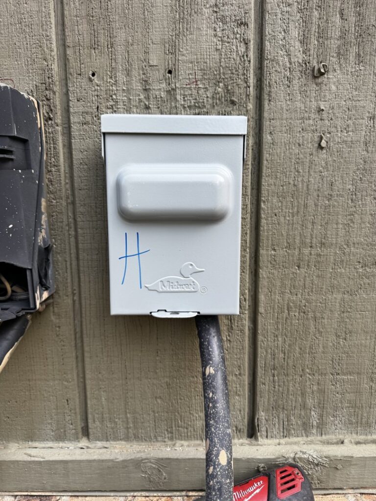 An electrical disconnect box for an outdoor HVAC unit, installed by OnPoint Heating and Air in Commerce City, CO.