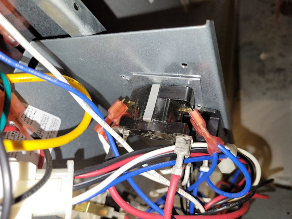 Close-up of electrical wiring and components inside an HVAC unit being serviced by Comfort Hounds Heating & Cooling in Raleigh, NC.