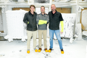 Three HVAC engineers stand in a frozen equipment room at Perry Tillman TM Air Engineers in Birmingham, AL.