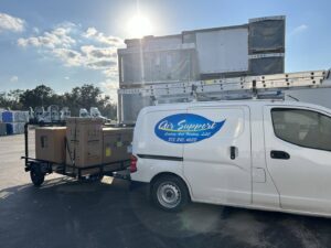 Air Support Cooling and Heating, LLC van with a trailer delivering new HVAC equipment for installation in Tampa, FL