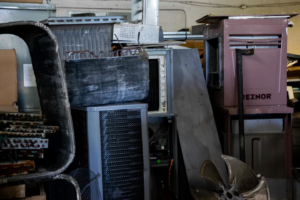 Various HVAC equipment and parts stored in a workshop, demonstrating the scope of work by AirTemp Heating & Cooling in Nashville, TN.
