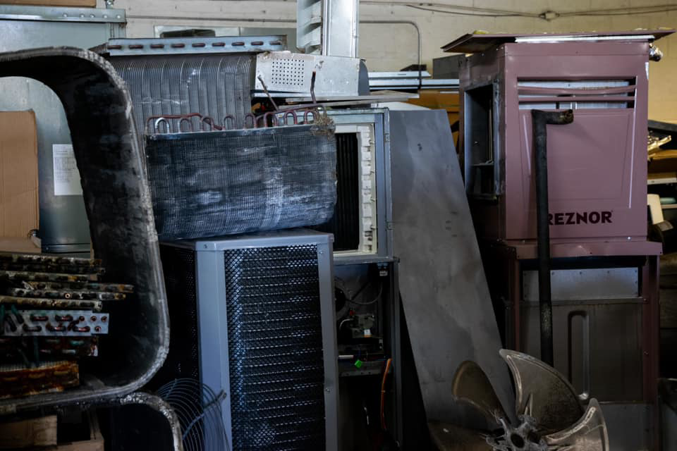 Various HVAC equipment and parts stored in a workshop, demonstrating the scope of work by AirTemp Heating & Cooling in Nashville, TN.