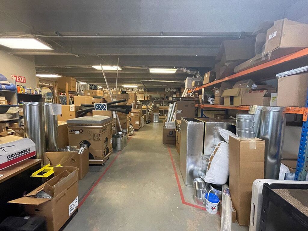 A warehouse filled with HVAC equipment, parts, and ductwork ready for projects at HVAC Solutions in Colorado Springs, CO