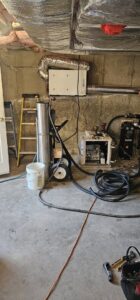 HVAC equipment and service tools in a basement work area by Ultra Installs in Barrington, NH