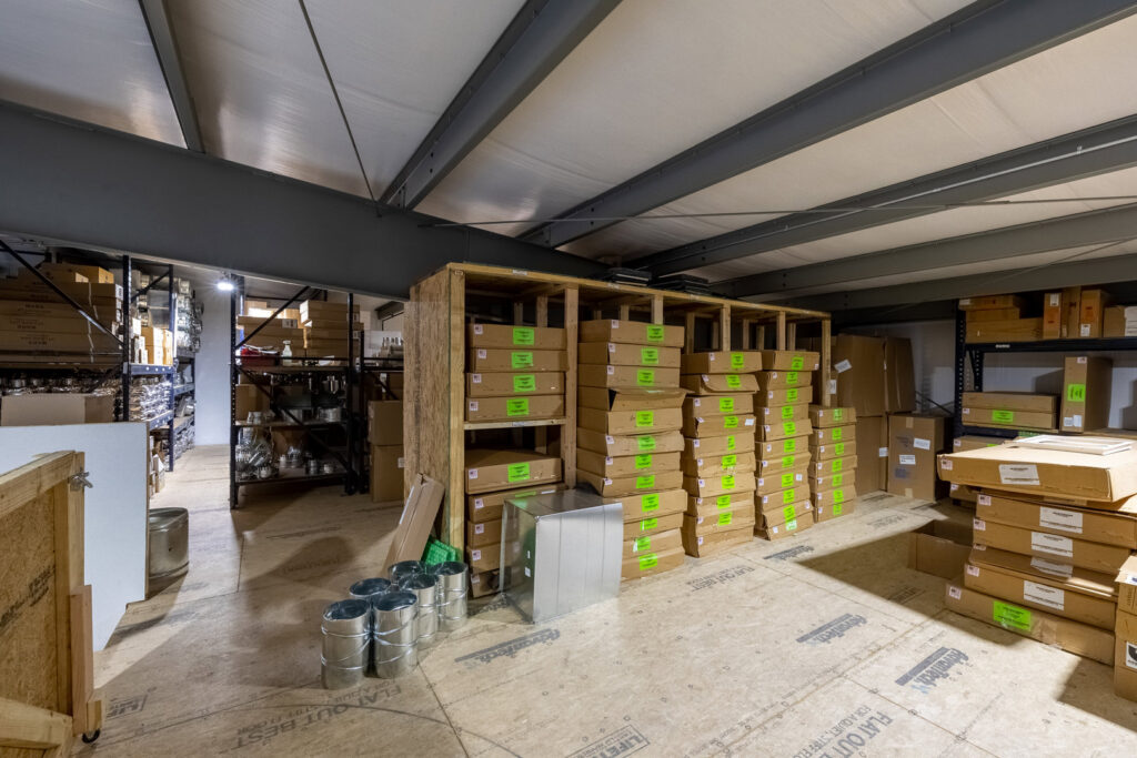 An organized warehouse storing HVAC equipment and supplies for Prudhom Mechanical LLC in Edmond, OK