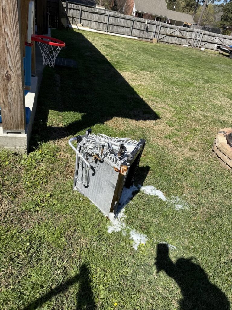 An old HVAC evaporator coil being cleaned or prepared for replacement by Emergency Air in Chandler, AZ.