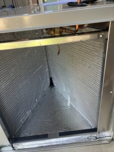 A close-up view of an HVAC evaporator coil inside an air handler, serviced by Blue Sky Heating and Air in Austin, TX.