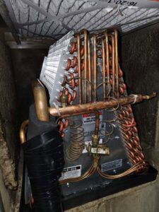 Close-up view of an HVAC evaporator coil during an inspection or service by Steadfast Mechanical in Gilbert, AZ.