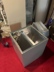 An evaporator coil inside an HVAC air handler, being inspected by Trade Allies Heating and Cooling in Ankeny, IA.