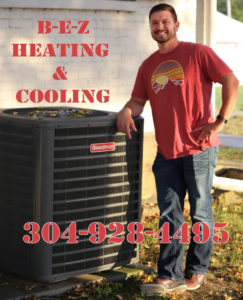 An HVAC expert from B E Z Heating and Cooling standing next to an outdoor Goodman air conditioning unit in Huntington, WV.