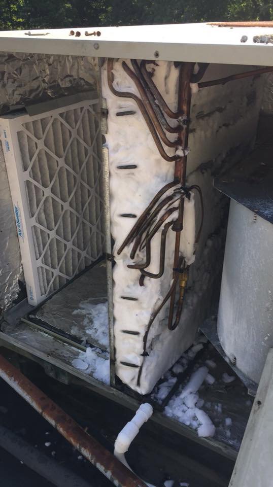 An HVAC filter next to an iced coil inside a unit, requiring repair from Raleigh Comfort Services in Raleigh, NC.