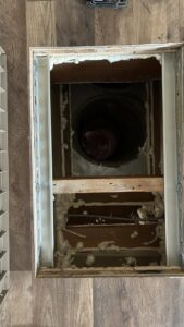 Close-up view of HVAC floor ductwork with insulation foam, indicating installation or repair by Service Kings Heating and Air in Jamestown, ND.