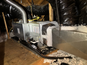 An HVAC furnace and air handler unit with ductwork installed in an attic by Dan Deckard Hvac in Charlotte, NC