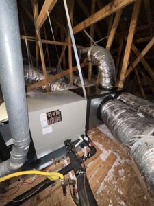 An HVAC furnace and air handler unit with ductwork installed in an attic by EZ Comfort Air Conditioning & Heating LLC in Humble, TX.