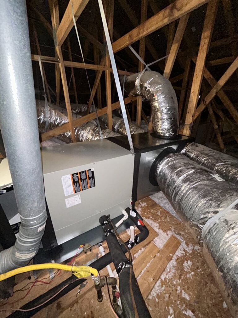 An HVAC furnace and air handler unit with ductwork installed in an attic by EZ Comfort Air Conditioning & Heating LLC in Humble, TX.