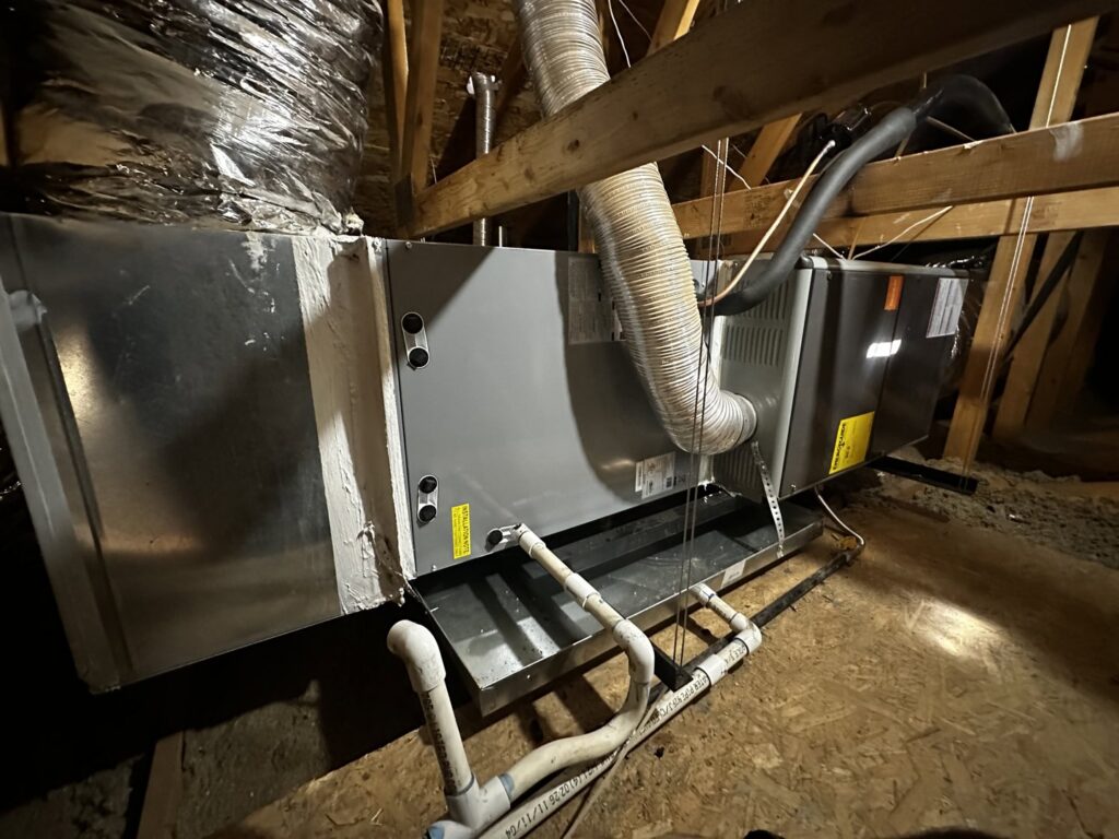 An HVAC furnace and air handler unit with ductwork installed in an attic by Rios Brothers Heating and Cooling LLC in Gilbert, AZ.