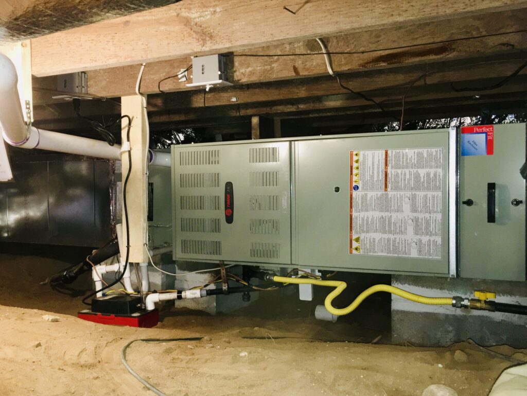 An HVAC furnace and air handler unit installed in a crawl space or basement by Modern Mechanical HVAC in Garner, NC.