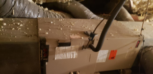 An existing indoor HVAC furnace or air handler unit with ductwork in a home serviced by Hobart Heating & Cooling Inc. in East Peoria, IL.