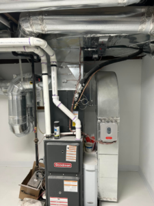 A newly installed Goodman HVAC furnace and air handler system with ductwork and piping by Omega Heating and Air Corp in Elizabeth, NJ.