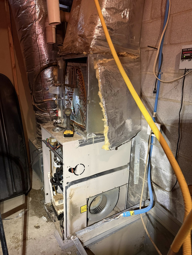 An HVAC furnace and air handler unit undergoing repair or maintenance by On-Target Heating & Air LLC in Rock Hill, SC.