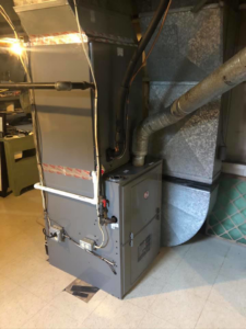 An indoor HVAC furnace and air handler system with extensive ductwork installed by Virtues Mechanical LLC in Baltimore, MD.