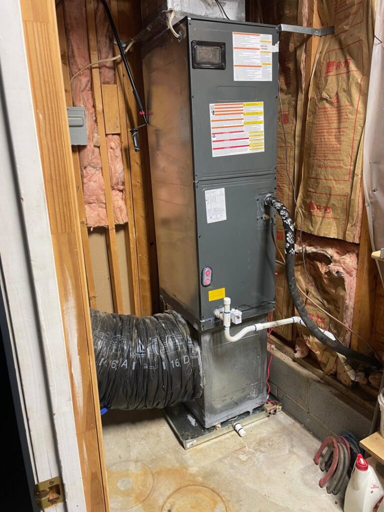 An HVAC furnace and air handler unit installed in a utility closet by Luciano's Air Services in Durham, NC.