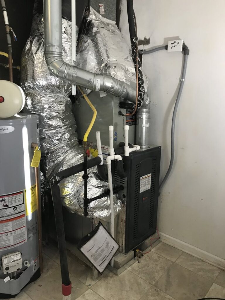 An HVAC furnace and air handler unit installed in a utility closet by Modern Mechanical HVAC in Garner, NC.