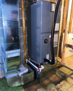 An indoor HVAC furnace and air handler unit with ductwork in a utility room by Vico&Son HVAC Services and Sheet Metal LLC in Beltsville, MD.
