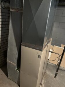 An HVAC furnace unit connected to extensive metal ductwork, installed by Lyons Heating and Cooling in Lyons, OR.
