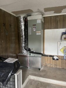 An HVAC furnace and ductwork installed in a utility area by Willman Air in Jacksonville, FL.