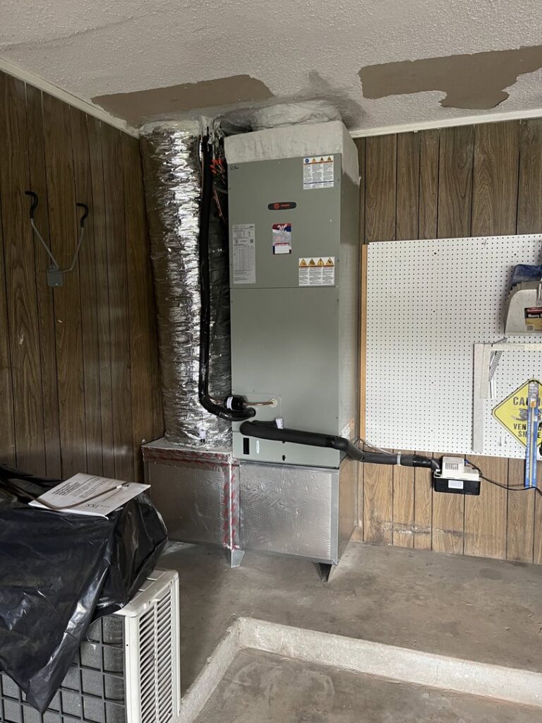 An HVAC furnace and ductwork installed in a utility area by Willman Air in Jacksonville, FL.