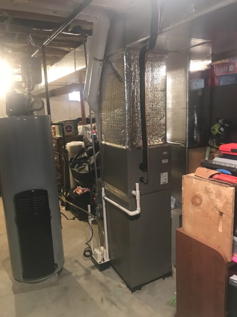 An HVAC furnace and water heater system in a basement by Quality Comfort Inc. in Aston, PA