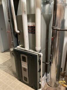 HVAC furnace and water heater system installed in a utility room by ALC Universal in Sheridan, WY.