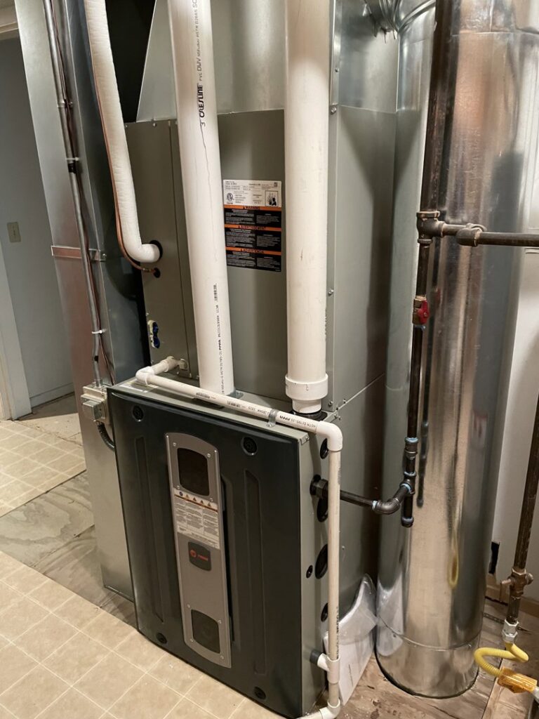 HVAC furnace and water heater system installed in a utility room by ALC Universal in Sheridan, WY.