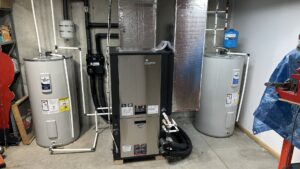 A newly installed HVAC furnace and two water heaters in a utility room, showcasing Prime Home HVAC's installation work in York, PA.