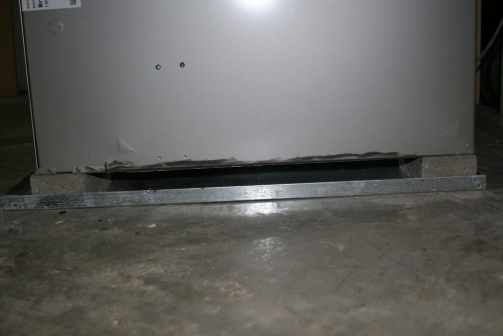 A close-up view of the base of an HVAC furnace unit during installation by Stivers Heating & Air Conditioning Inc. in Louisville, KY