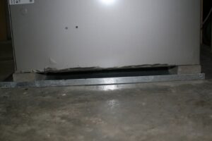 A close-up view of the base of an HVAC furnace unit during installation by Stivers Heating & Air Conditioning Inc. in Louisville, KY