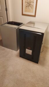HVAC furnace and air handler components on a carpeted floor, ready for replacement or installation by C&L Heating and Air in Louisville, KY.