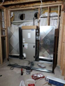 New Carrier HVAC furnace and ductwork installation in a basement utility room by Ambiaire in Lakewood, NJ