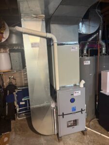 An indoor HVAC furnace and ductwork installation in a residential basement by Davenport Service Company in Olathe, KS