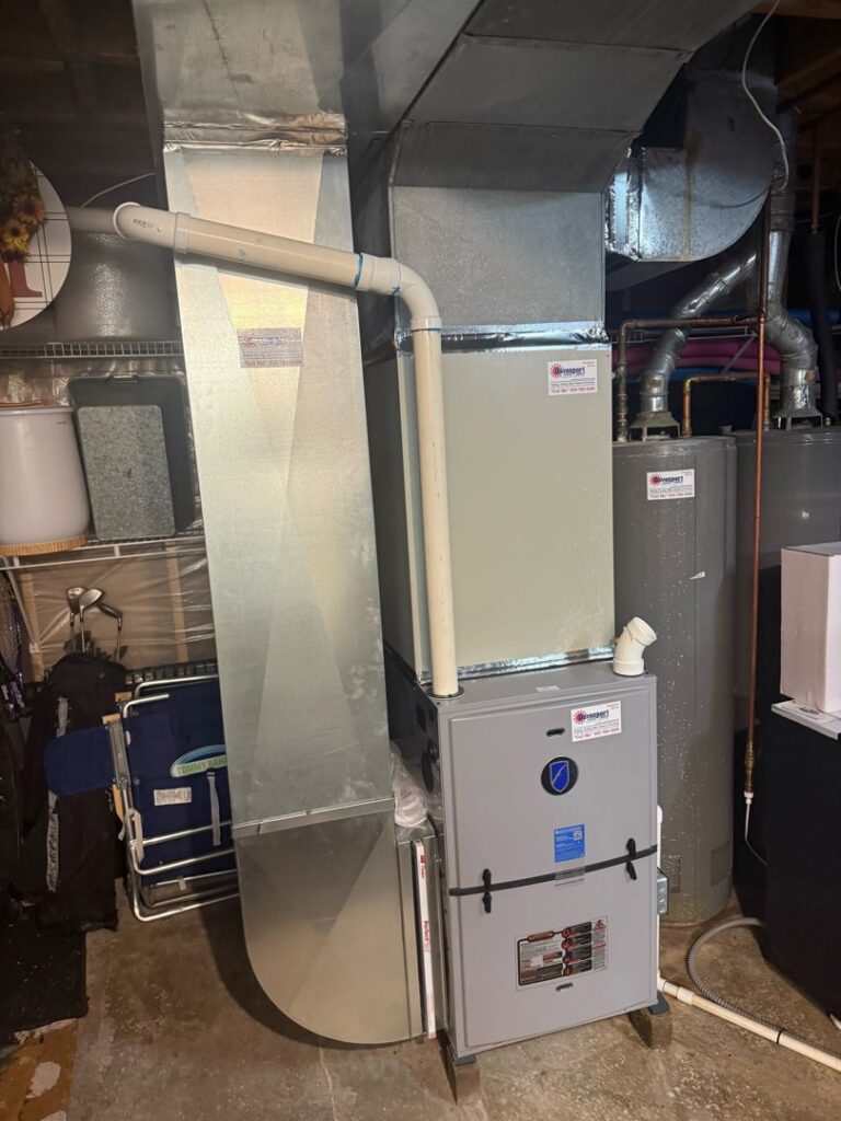An indoor HVAC furnace and ductwork installation in a residential basement by Davenport Service Company in Olathe, KS