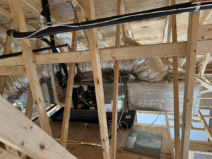 An HVAC furnace and ductwork installation in a residential attic by Ferreira Mechanical, LLC in Fall River, MA